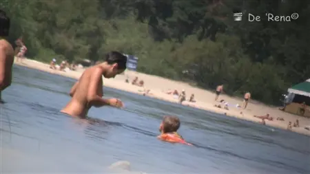 Peeping derrière des personnalités nues sur une grande plage nudiste